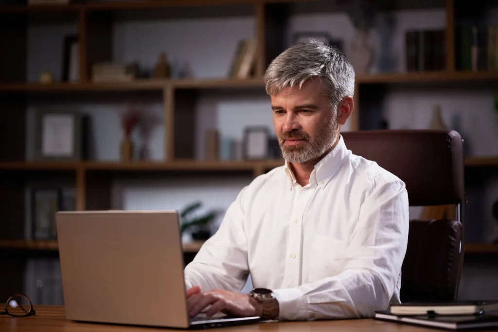 middle aged man freelancer in glasses working